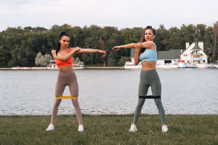 Vital and determined motivated Young women training together an outdoorの写真素材