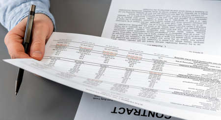 Cropped view of businessman works with financial papers at the table. Finance concept