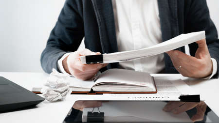 Cropped view of businessman works with financial papers at the table. Finance conceptの写真素材