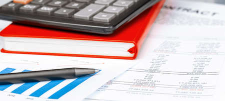 Calculator on financial papers at the table close up. Finance conceptの写真素材