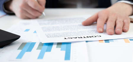 Cropped view of businessman signs a document or contract. Finance conceptの写真素材