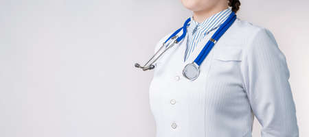 Cropped view of Woman doctor in a white coat with stethoscope. Isolated over white background. Copy space for your text