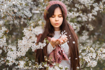Pretty child brunette girl 11-12 years in blossom garden. Fashion conceptの写真素材