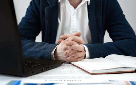 Cropped view of businessman works with financial papers at the table. Finance and business conceptの写真素材