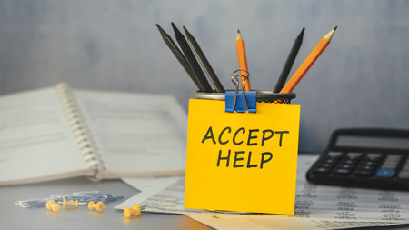 Accept Help - concept of text on sticky note. Closeup of a personal agendaの写真素材