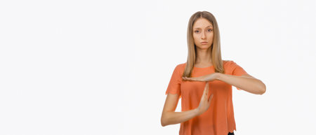 Young blond woman in casual clothes showing time out gesture. Human emotions, gesture concept....