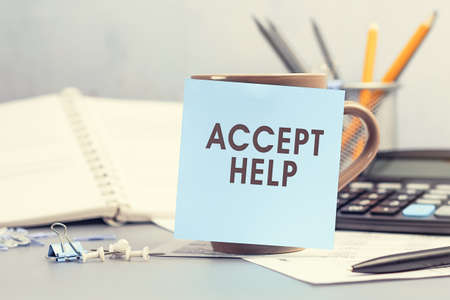 Accept Help - concept of text on sticky note. Closeup of a personal agenda