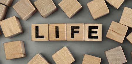 LIFE - word concept from wooden blocks. Wooden cubes with lettersの写真素材