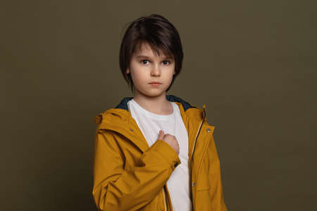 True human reactions, emotions and feelings. Confused little boy in casual clothes having scared look, pointing index finger at himself, asking Who meの写真素材