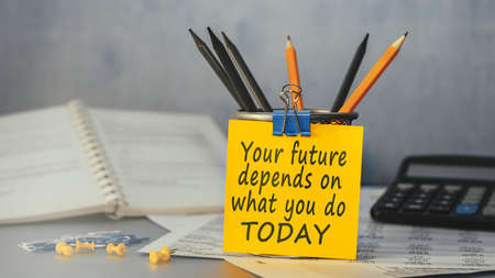 Your future depends on what you do TODAY - concept of text on sticky note. Closeup of a personal agendaの写真素材