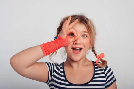 Funny cute little girl playing with her hair. Happy girl. True human emotions and feelings