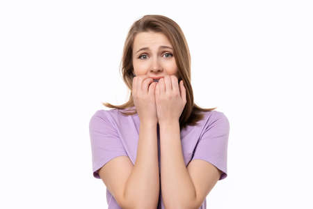 CanT Say Anything. Close up shocked young woman covering her mouth with hands, isolated on white...