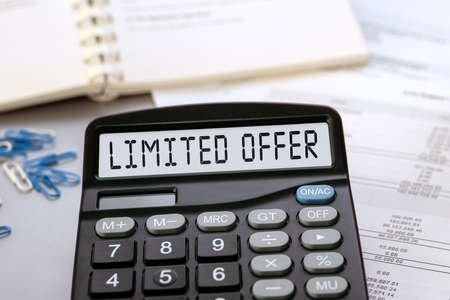 Calculator with the words LIMITED OFFER on the display. Money, finance and business conceptの写真素材