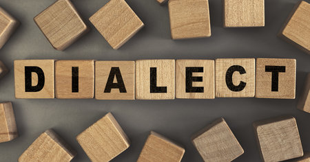 The word DIALECT on small wooden blocks at the desk. Conceptual photo. Top viewの写真素材