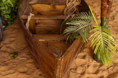 Close-up old wooden boat on gold beach on warm sunset. Studio shotの写真素材
