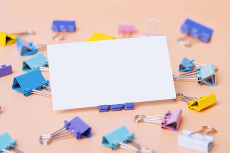 blank sheet of paper for notes with stationery clips, template with copy space for text. Still life, business, office supplies or education conceptの写真素材