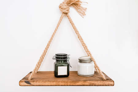 Minimal mockup background for product presentation. Wood shelf on plaster wall with set of cosmetic productsの写真素材