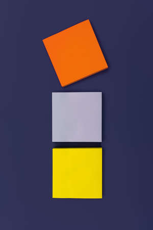 Three blank color square sticky note on purple background, top view. Blank space for future important events announcements. vertical photoの写真素材