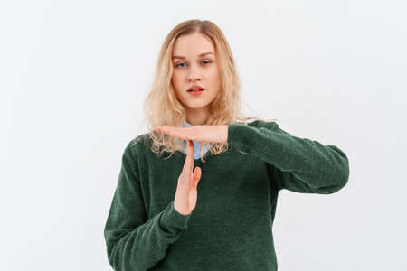 Young dissatisfied girl with fair-haired gesture shows timeout, needs stop, asks time for rest after...