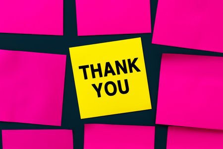 Thank you message on card for presentation, business. Yellow sticker among pink note papers. business concept. home office. info conceptの写真素材
