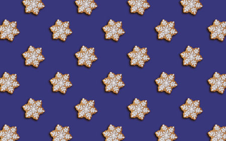 Christmas cookie pattern. Dark blue seamless background. Snowflake shaped gingerbread cookie, minimal print for new year card. Happy new year and merry christmas conceptの写真素材
