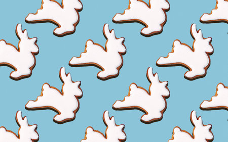 Seamless pattern of cookies in the shape of White deer, on a blue background, minimal print for new...