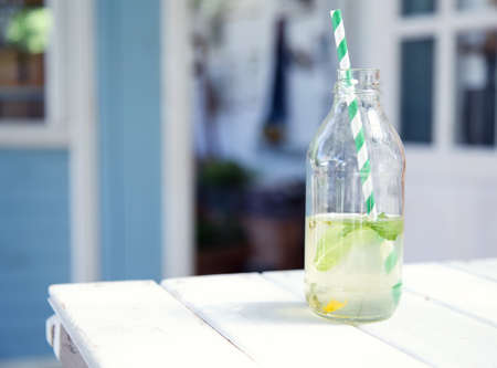 Bottles with lemonade. Drink fresh lemonade on a hot summer day in nature. Place for text.の写真素材