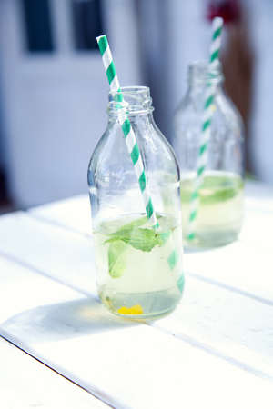 Two bottles with lemonade. Drink fresh lemonade on a hot summer day in nature. Place for text.の写真素材