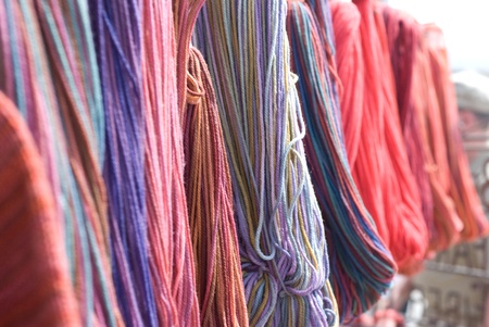 Skeins of colorful yarn hanging, shallow DOFの写真素材