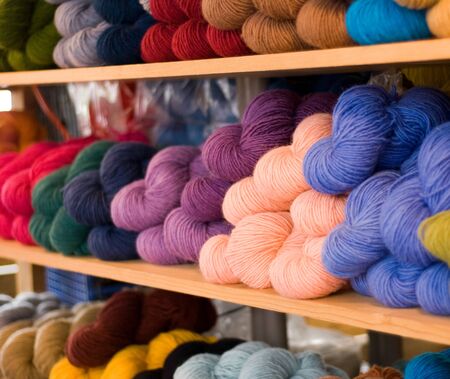 Wood shelves of colorful yarnの写真素材