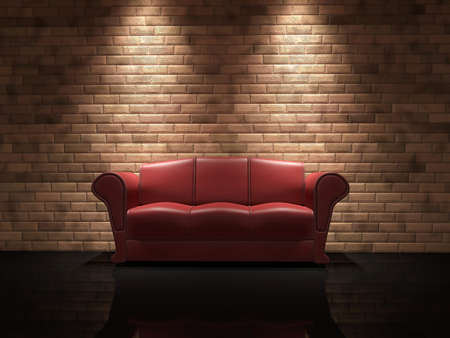 Red leather sofa near a brick wallの写真素材