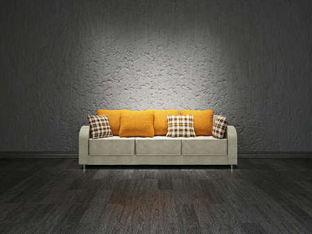 Sofa with pillows near the concrete wallの写真素材