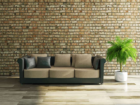 Sofa with pillows near a brick wallの写真素材