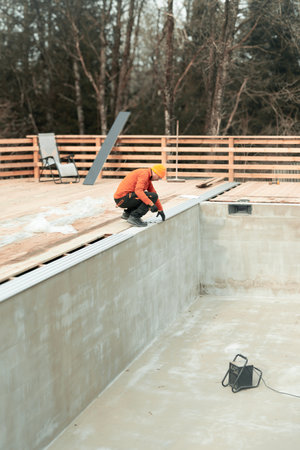 Dedicated Construction Worker Actively Engaged in the Comprehensive Pool Building Processの写真素材