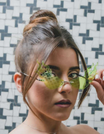 Pretty woman with green green glasses of flames