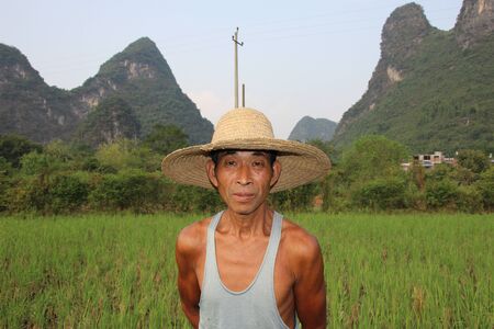 Farmer Yangshuo karst landscape ricefields Chinaのeditorial素材