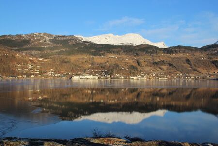Snow mountain reflecting in Eidfjord Ulvik Norwayの写真素材