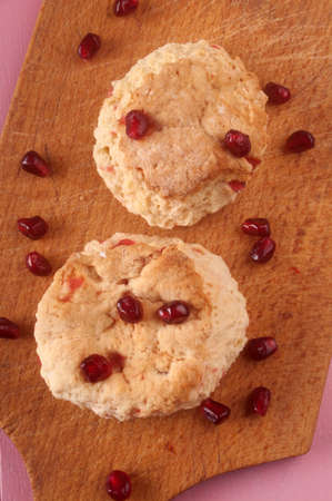 fruit scone with pomegranate seed on a wooden boardの写真素材