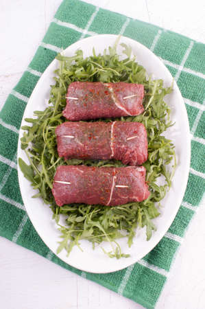 beef rolls with rocket salad on a large plateの写真素材
