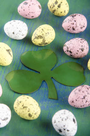 easter eggs and an Irish shamrock on blue green woodの写真素材