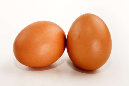 two brown chicken eggs, isolated on white backgroundの写真素材