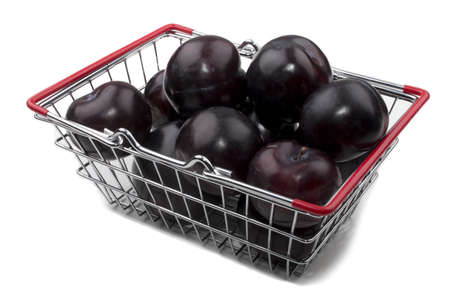 sweet and organic plum in a shopping basket on whiteの写真素材