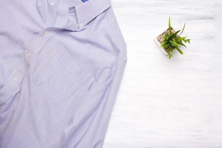 Messy businessman shirt on white wooden background. Business and office concept. Lifestyle.の写真素材