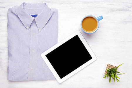 Top view of businessman items on white wooden table, with blank tablet with copyspace. Business and lifestyle concept.の写真素材