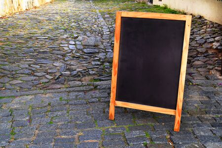 Empty chalkboard or blackboard on the street with copyspace. Blank menu board with space for text.の写真素材
