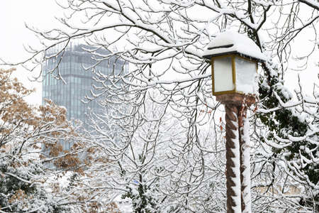 A winter view of a lantern on upper town Zagreb with a skyscraper on the main square in the background.の写真素材