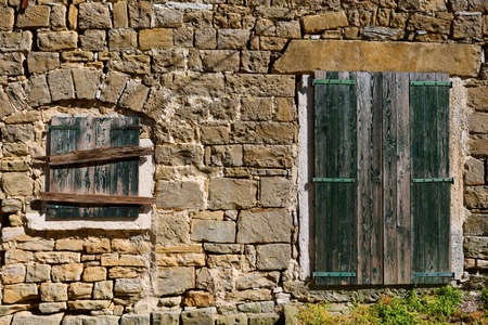 Wall of a worn down traditional mediterranean stone house.の写真素材