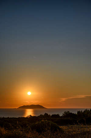Sunset over a remote islandの写真素材