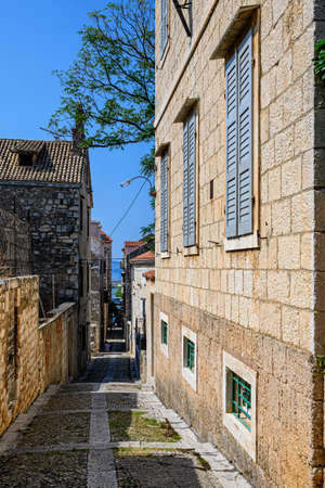 Long and narrow cobblestone street in the old town of KomiÅ¾a, on Vis island, Croatia.