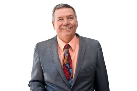 Portrait of a senior businessman looking into the camera, smiling, isolated on a white background.